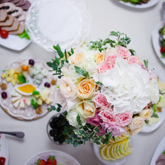 Wedding floristry. Beautiful lush bouquet on the table in restaurant