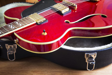 Naklejka premium Red acoustic guitar close up in dark background