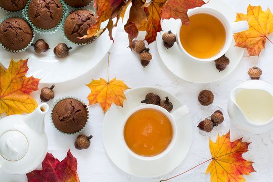 Two cups of english tea with milk on white table cloth