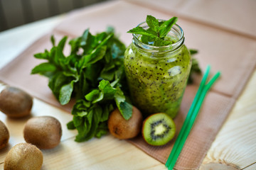 Fresh green smoothie with kiwi and mint . Love for a healthy raw