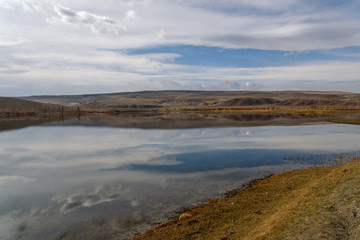 Fototapeta na wymiar lake mountains steppe sky clouds
