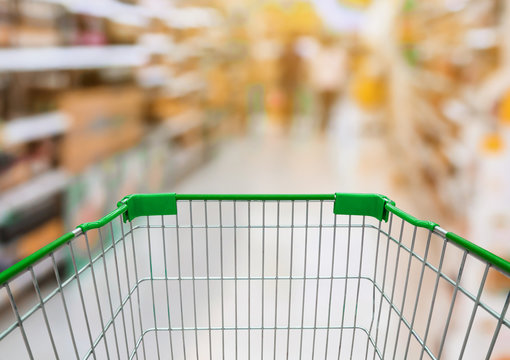 Shopping cart with Supermarket Aisle with product on Shelves