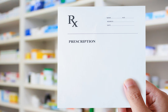 Hand Hold Prescription Paper Over The Pharmacy
