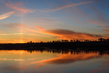 Fototapeta na wymiar lake sunrise sky clouds reflection
