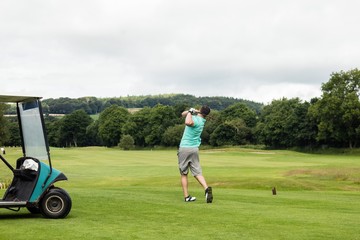 Rear view of man playing golf