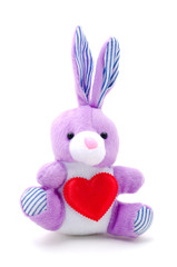 light purple toy bunny rabbit sitting with heart.