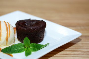 Chocolate fondant with ice-cream and mint leaves.