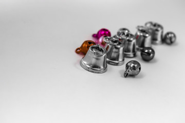 Obraz premium Small silver bells on white background. Silver bells on white background