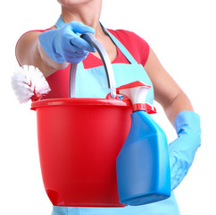 Woman in apron with bucket of cleaning supplies on white