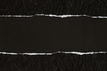 Ripped crumpled black paper with space