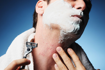 Closeup miserable male man shaving with razor burn bumps nicks cuts rash easily isolated