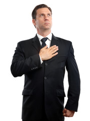Somber male man veteran politician businessman looking up with hand over heart swearing pledging lying isolated on white background