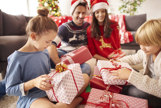 Happy family start opening Christmas presents