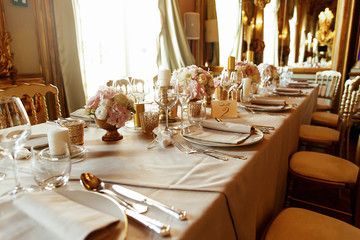 Table number two stands before the window in rich Italian hall