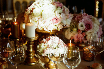 Ray of light illuminates white bouquets on the dinner table