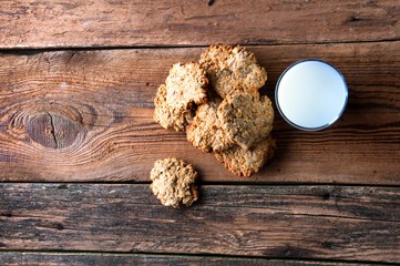 Milk and cookies on wooden table. Copyspace
