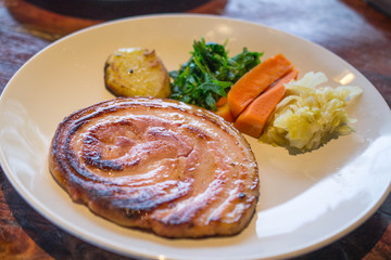 Sausage grill with vegetable on white dish