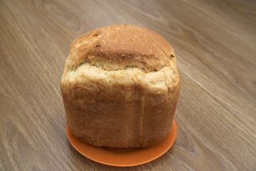 A loaf of white bread on a wooden table