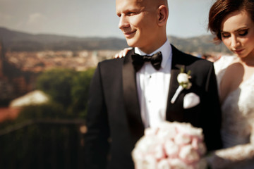 Blurred picture of daydreaming bride standing behind groom