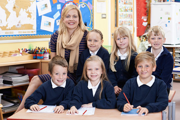 Portrait Of Teacher In Class With Pupils