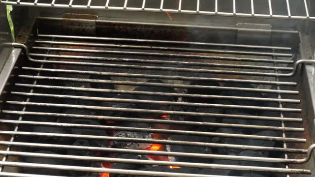 Heating a charcoal grill for a barbecue