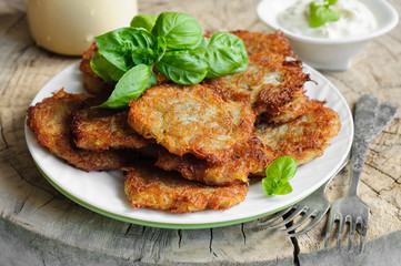 Potato pancakes and sour cream in plate