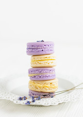 Lavender and vanilla macarons on white plate
