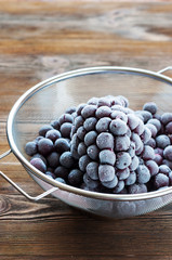 Frozen berries in sieve