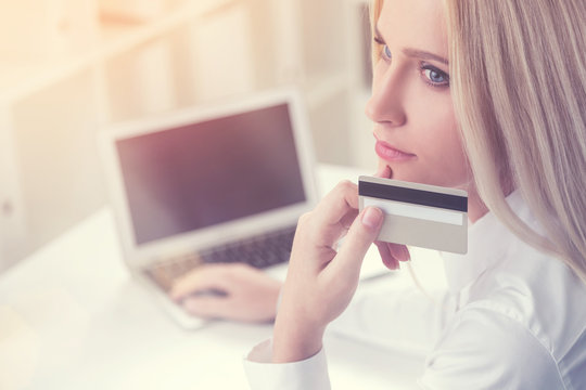 Thoughtful Businesswoman With Gray Card