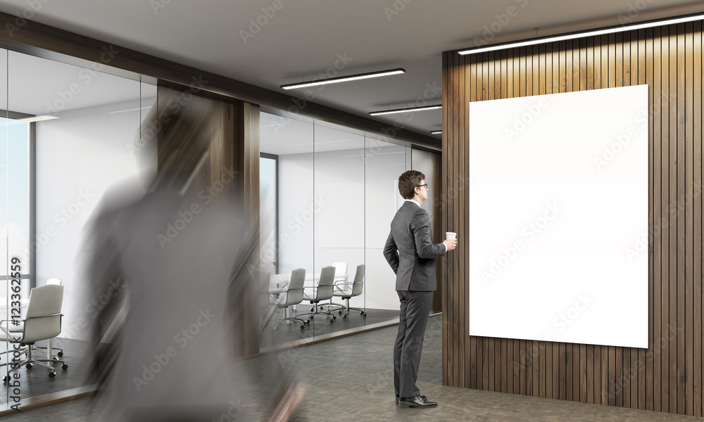 Wall mural Man looking at poster in office