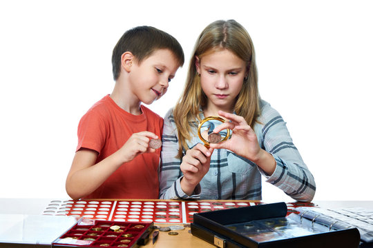 Boy and girl are considering coin collection isolated