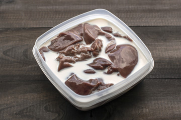 raw turkey liver in milk in plastic container