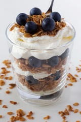 Glass of muesli with cream and berries