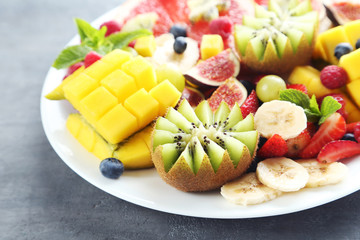 Fresh fruit salad on a grey wooden table