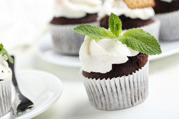 Chocolate cupcakes on a white wooden table