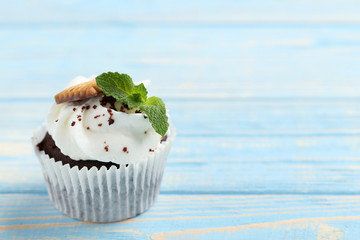Chocolate cupcake on a blue wooden table