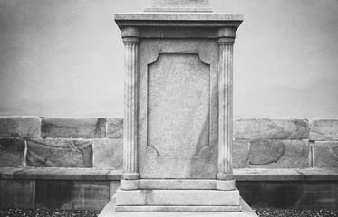 Decorated stone pedestal. Architecture is made in classicist style. Black an white with vignetting