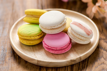 macaron in plate on wood table