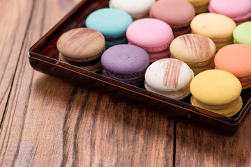 Macaron in plate on wood table