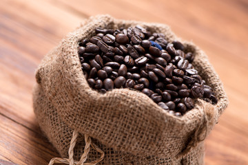 coffee bean in sack on wood table background