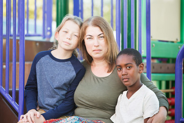 Adult woman sitting with two boys