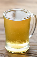 Beer in mug glass on wood table,top view