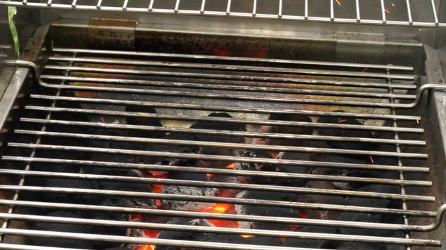 Heating a charcoal grill for a barbecue