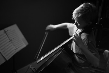 Young boy playing cello, black and white