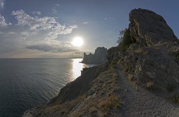 Coastal cliffs illuminated by the evening sun.