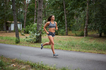 Young woman running outdoors in a city park