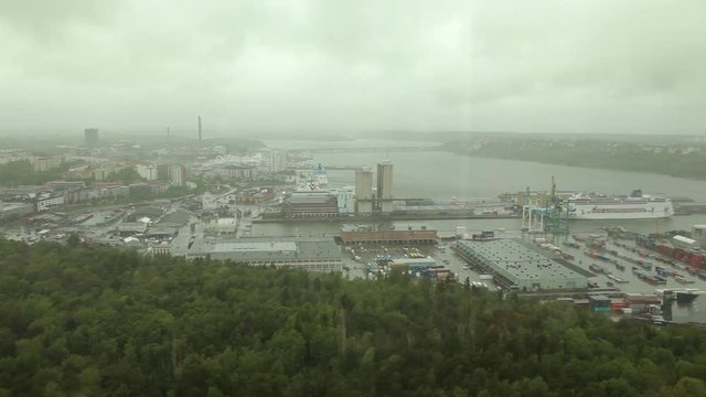 Stockholm aerial view from Kaknas Tower with a port area in a cloudy day. Seen through a wet glass.