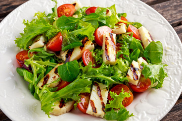 Grilled Halloumi Cheese salad witch tomatoes and lettuce. healthy food
