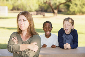 Frustrated mother with children at park