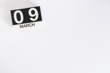 March 9th. Day 9 of month, wooden color calendar on white background. Spring time, empty space for...